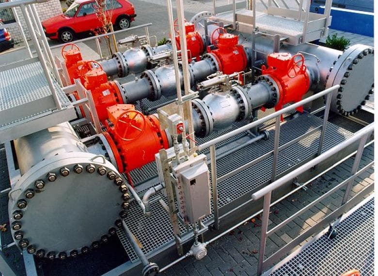 Axial surge relief valve skid